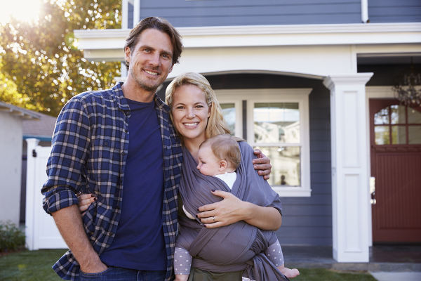 family in front of house