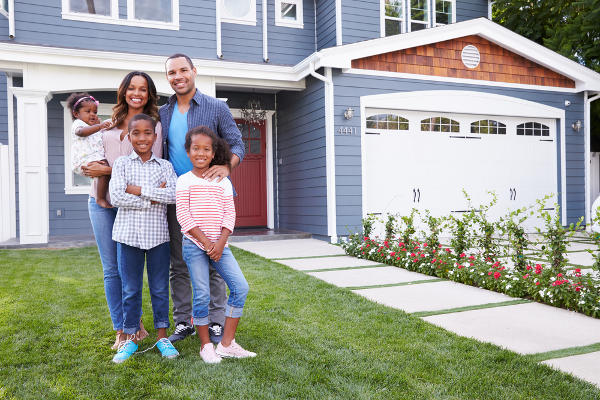 family in front of house