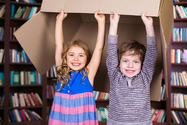 kids holding box overhead